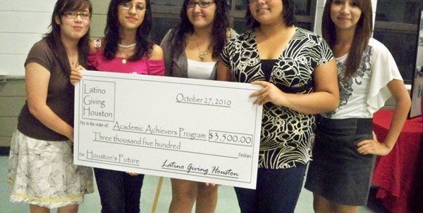 Latino students from Houston Academy donate a large sum of money they raised to a charitable organization.