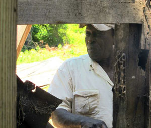 Junior Meggett, 76, looks into the slave cabin where his aunt and uncle once lived on Edisto Island, S.C., on Monday, May 13, 2012. The cabin was being taken apart and shipped north where it will one day be displayed at the Smithsonian National Museum of African American History and Culture opening in 2015 on the National Mall in Washington, Meggett grew up in a nearby cabin that was destroyed by fire. Photo Credit: Bruce Smith